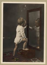 child looking in mirror