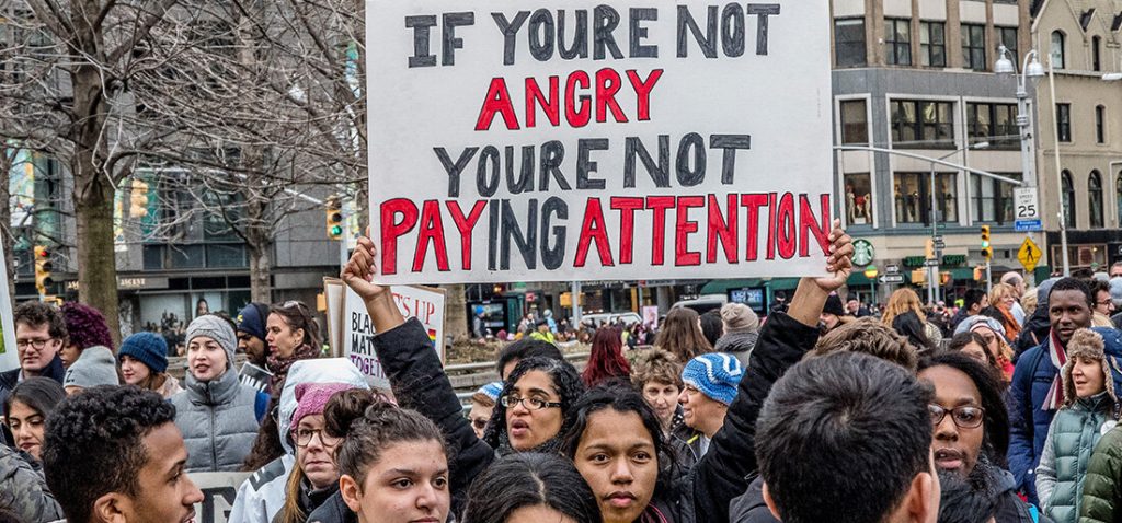 "if you're not angry your're not paying attention" sign