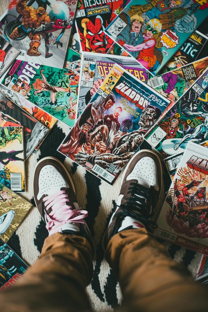 Person Standing on a Pile of Comics by Erik Mclean